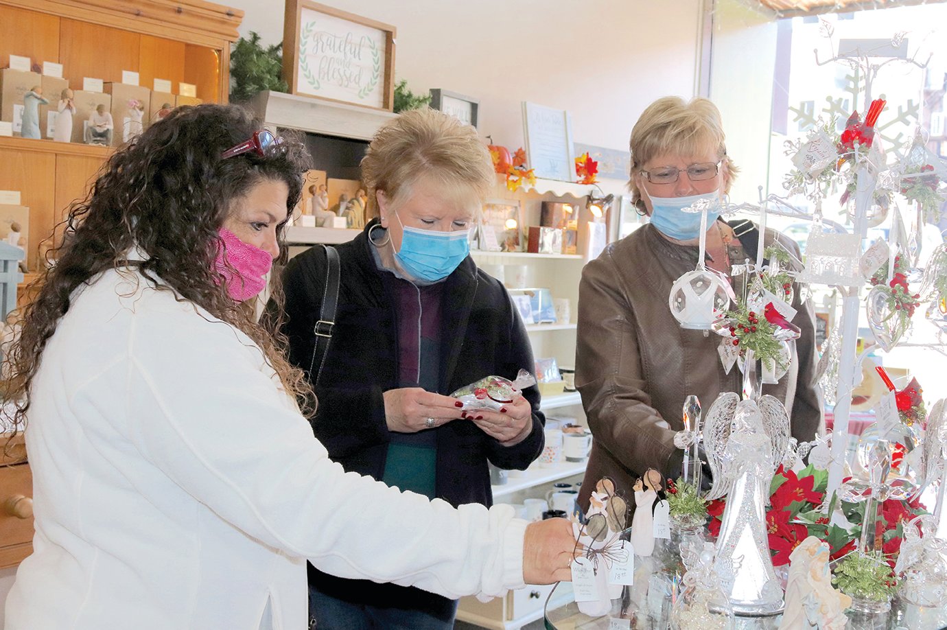 Holiday shoppers Karla Patty Murray, from left, Tammy Whetzel and Karla Jackson peruse items at In His Time downtown Friday afternoon.